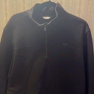 A Calvin Klein top with a zipper. It’s black good for upcoming colder climates.